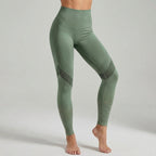 Green high-waisted performance leggings with ribbed side panels and dotted calf detail