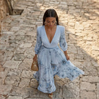 Blue floral maxi dress with V-neck, long sleeves, gathered waist and flowing skirt