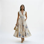 White maxi dress with V-neck and sleeveless shoulders, gathered waist, blue floral print