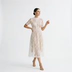 White lace midi dress with short sleeves and decorative floral pattern