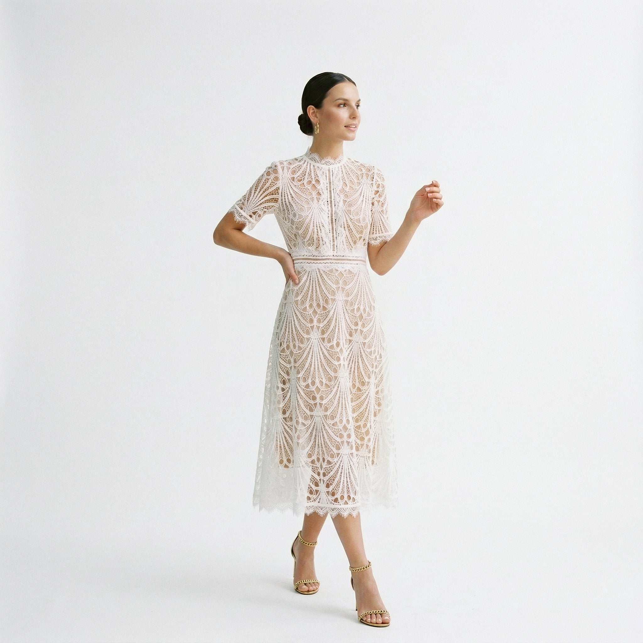 White lace midi dress with short sleeves and decorative floral pattern