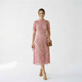 Pink lace midi dress with short sleeves and textured floral lace design