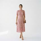 Pink lace midi dress with short sleeves and textured floral lace design