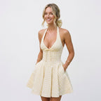 Light cream check halter mini dress with deep V neckline and pleated flared skirt