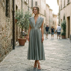 Grey pleated V-neck dress with short cap sleeves and cinched waist, mid-calf length