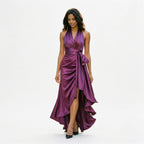 Fuchsia satin halter gown with draped twist front, tie detail, and high slit
