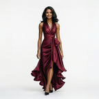 Red satin halter gown with draped twist front, tie detail, and high slit