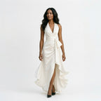 White satin halter gown with draped twist front, tie detail, and high slit
