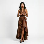 Brown satin halter gown with draped twist front, tie detail, and high slit
