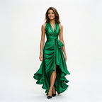 Green satin halter gown with draped twist front, tie detail, and high slit