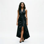 Black satin halter gown with draped twist front, tie detail, and high slit