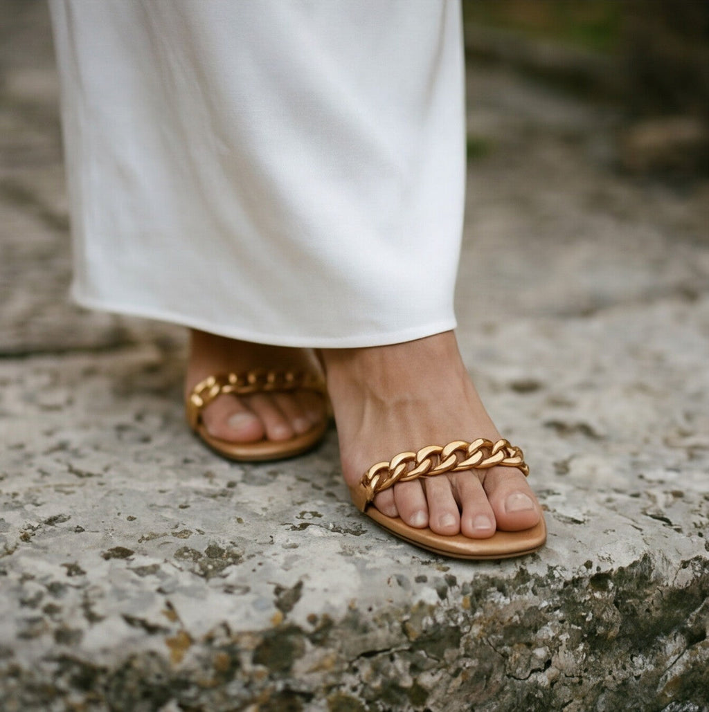 Cream maxi dress hem with tie waist detail, styled with flat sandals