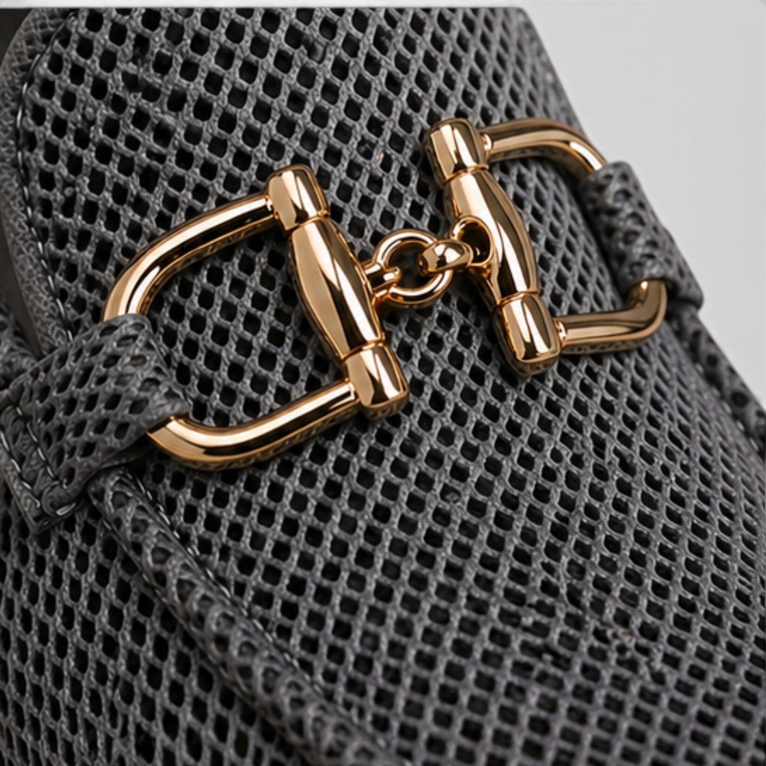 Dark mesh loafers detail, gold horsebit hardware on slip-on upper