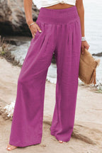 Pink high-waisted linen wide-leg trousers with elastic smocked waistband