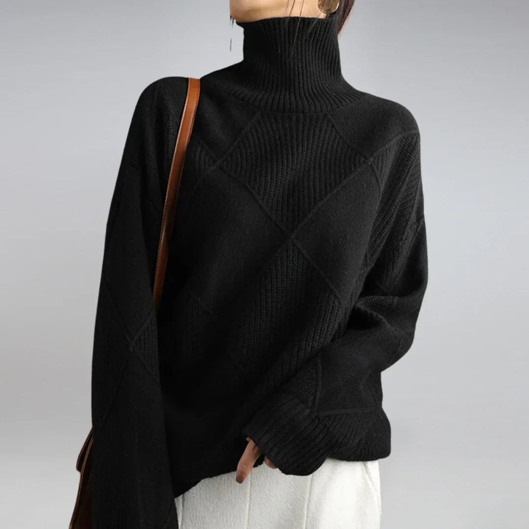Women’s cashmere turtleneck sweater in black with ribbed collar and diamond knit panel.