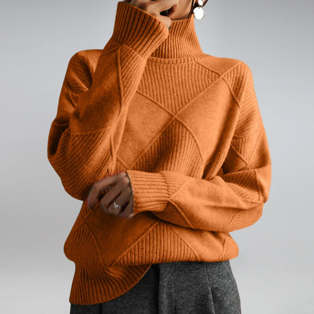 Women’s cashmere turtleneck sweater in rust orange, ribbed collar and textured diamond pattern.