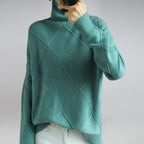 Women’s cashmere turtleneck sweater in teal, ribbed collar and diamond knit texture.