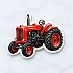 Red and black farm tractor acrylic ornament with hanging loop on white backing
