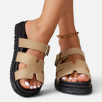 Beige platform sandals with adjustable ankle straps and open toe cutouts