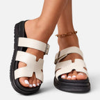 White platform sandals with adjustable ankle straps and open toe cutouts