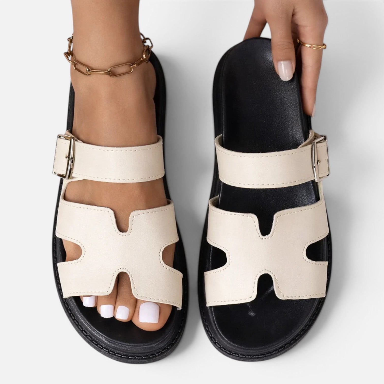 White platform sandals with two adjustable straps and open toe cutouts