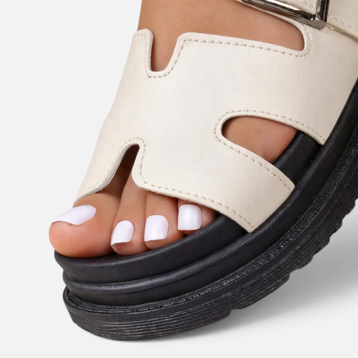 Beige platform sandals with adjustable strap and open toe cutouts