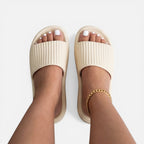 Women’s slide sandals in beige with ribbed upper and gold chain ankle strap
