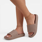 Beige women’s slide sandals with cushioned footbed and ribbed strap, open toe
