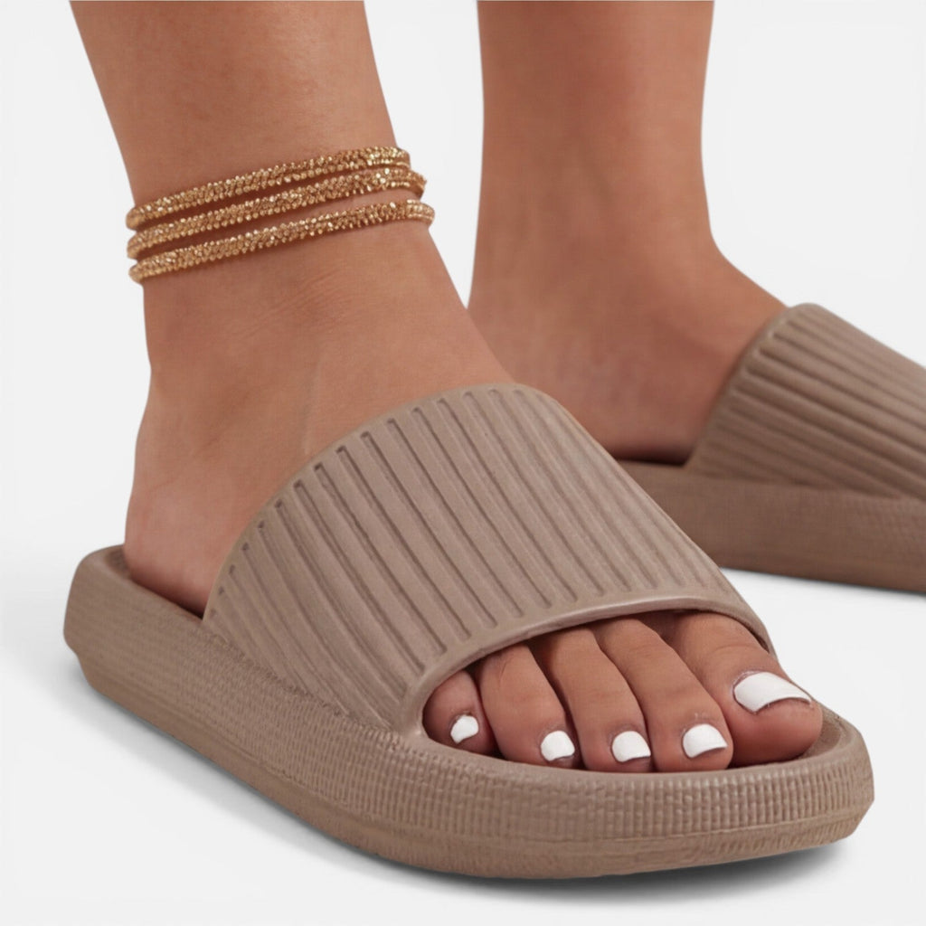 Women’s slide sandals in taupe with textured wedge sole and gold chain ankle strap