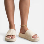 Women’s slide sandals in beige with ribbed upper and gold chain ankle strap
