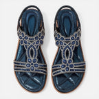 Pair of blue embellished slide sandals with jeweled floral designs and beaded trim