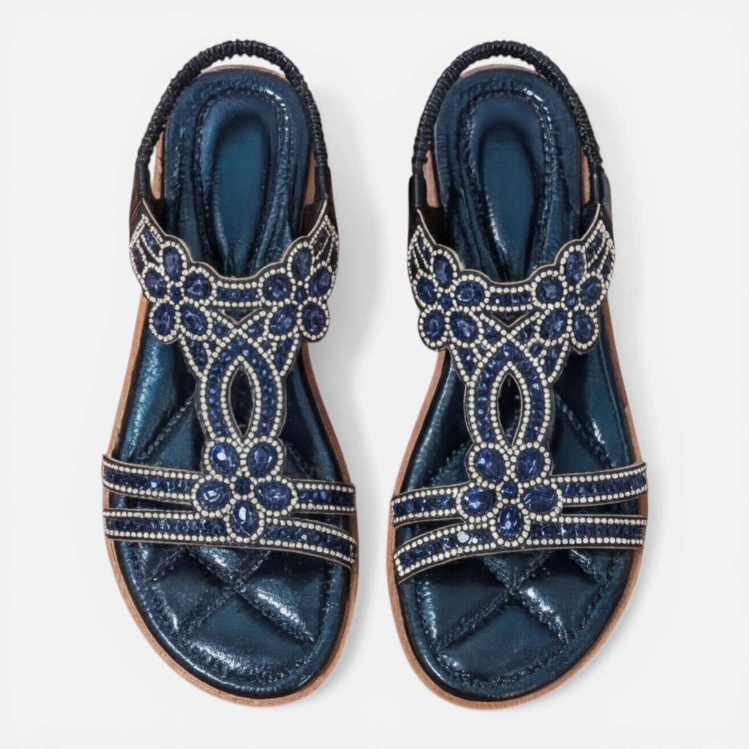 Pair of blue embellished slide sandals with jeweled floral designs and beaded trim