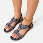 Blue open-toe embellished wedge sandals with ankle strap and gold chain bracelet