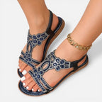 Blue beaded floral sandal with ankle strap, open toe, and dark sole