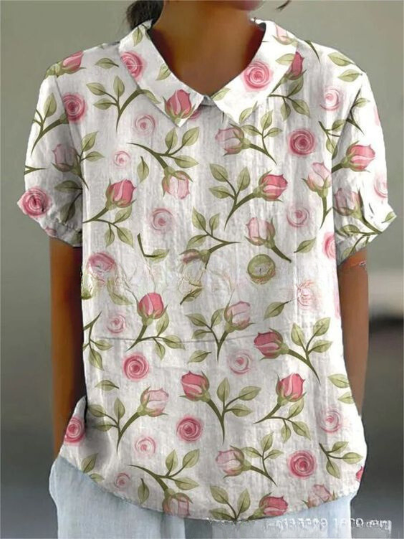 Floral print short-sleeve blouse in white with pink rose pattern and buttoned collar