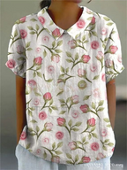 Floral print short-sleeve blouse in white with pink rose pattern and buttoned collar