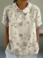 Floral print short-sleeve blouse in light cream with V-neck collar and buttons