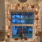 leaf garland border with warm fairy lights framing a double window