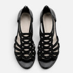 Women’s black sandals top view with open toe and lace-like cutout straps