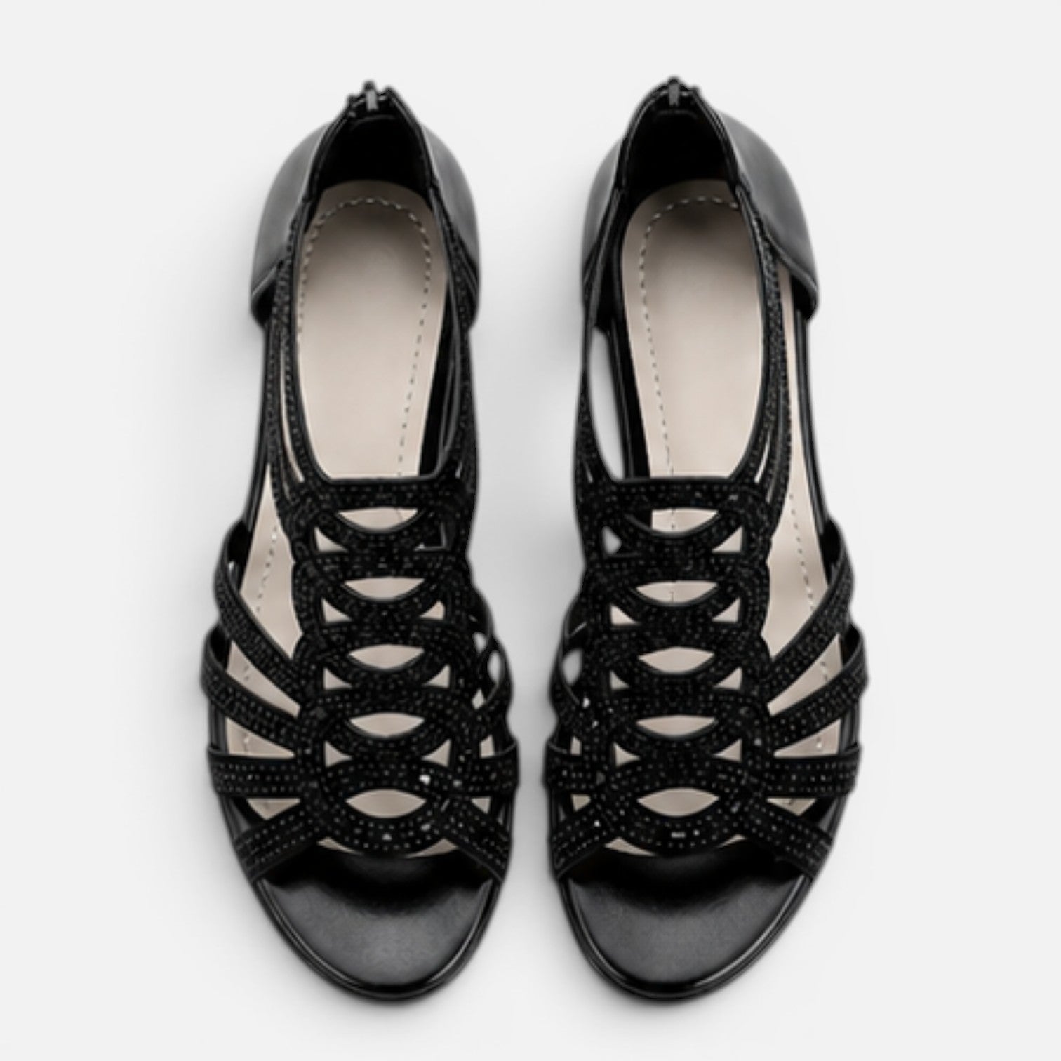 Women’s black sandals top view with open toe and lace-like cutout straps