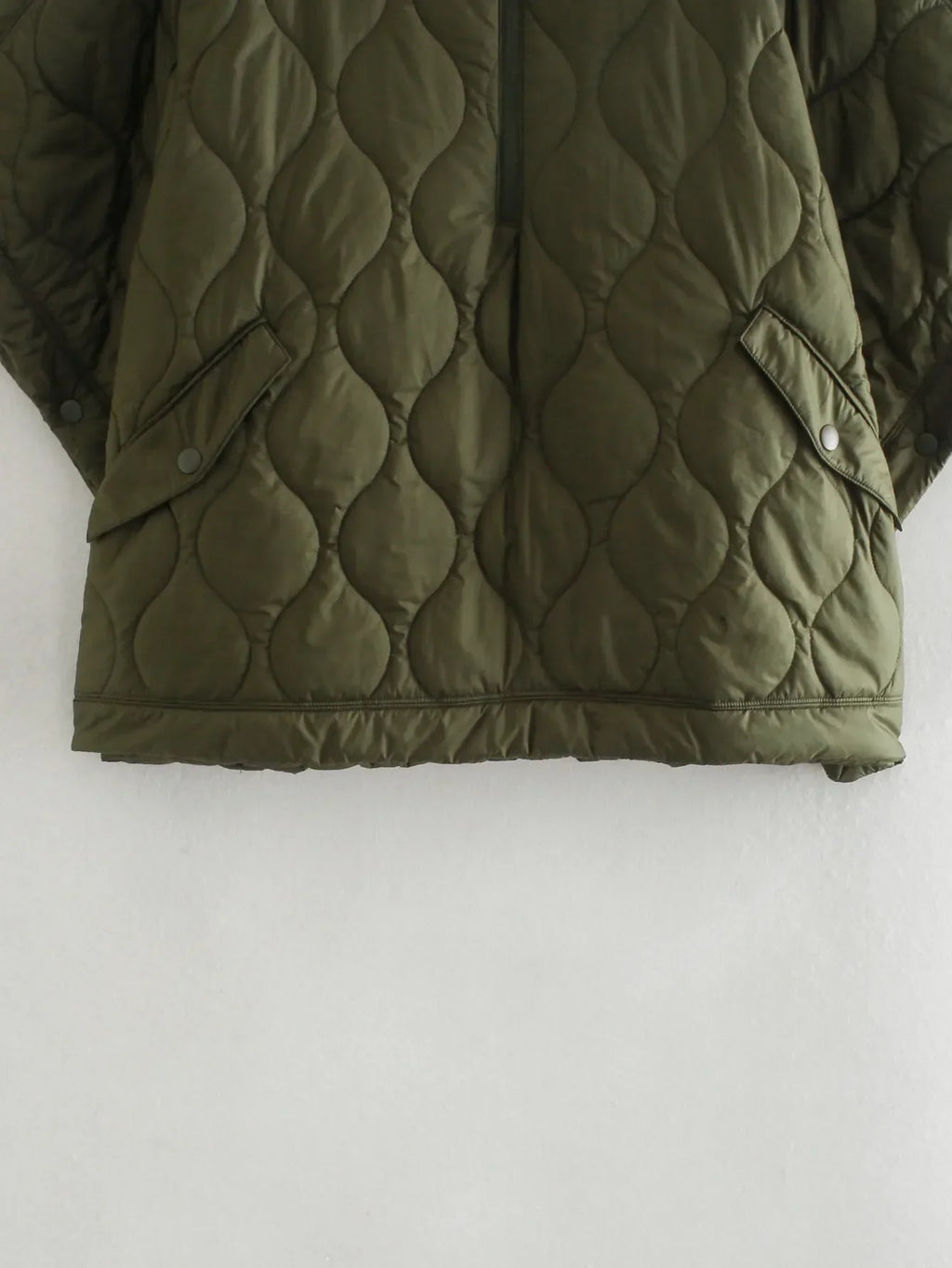 Olive quilted hem with snap-button placket, circular stitch pattern