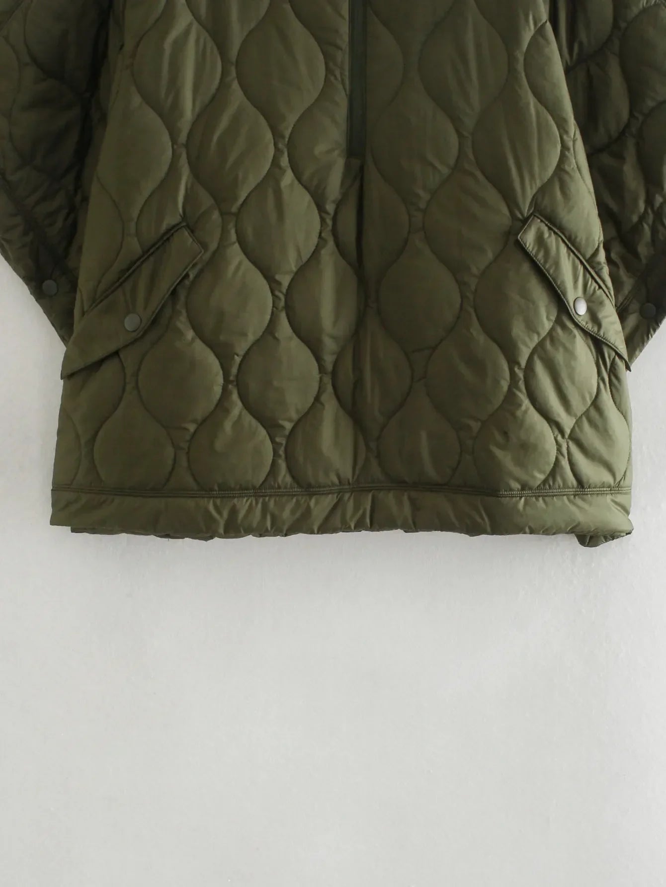 Olive quilted hem with snap-button placket, circular stitch pattern