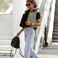 Women's quilted bodywarmer vest in black with olive-green front panels and zip front