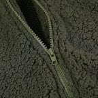 Olive green teddy vest zipper detail with metal pull and seam trim