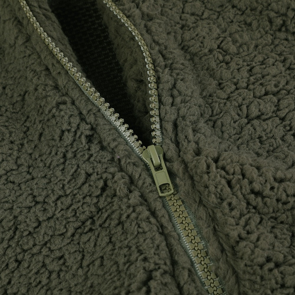 Olive green teddy vest zipper detail with metal pull and seam trim