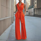 Bright red sleeveless wide-leg jumpsuit with lapel collar, button front, waist tie belt