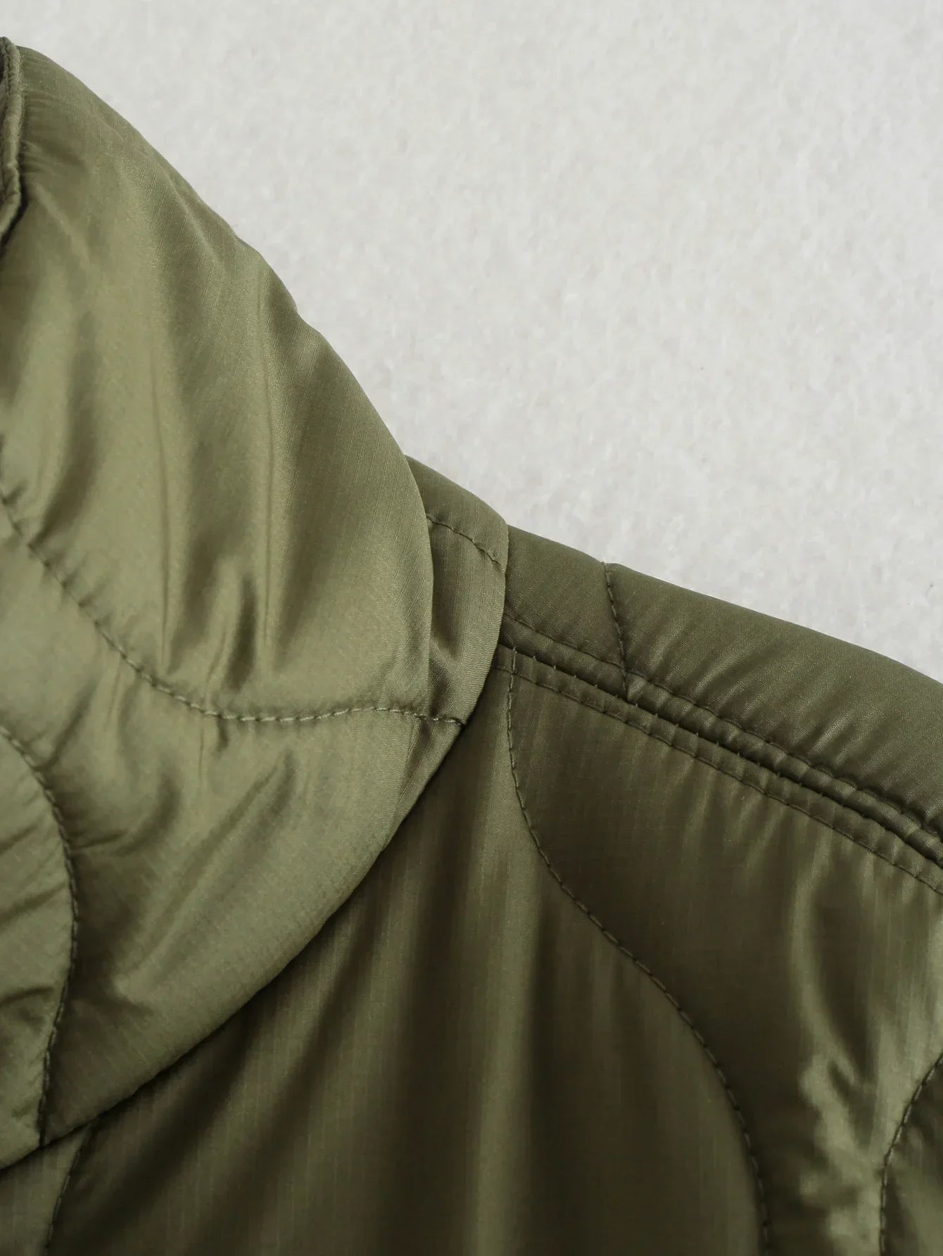 Olive quilted short-sleeve shoulder seam with stitched panel detail