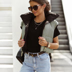 Women's quilted bodywarmer vest in black with green side panels and zip front