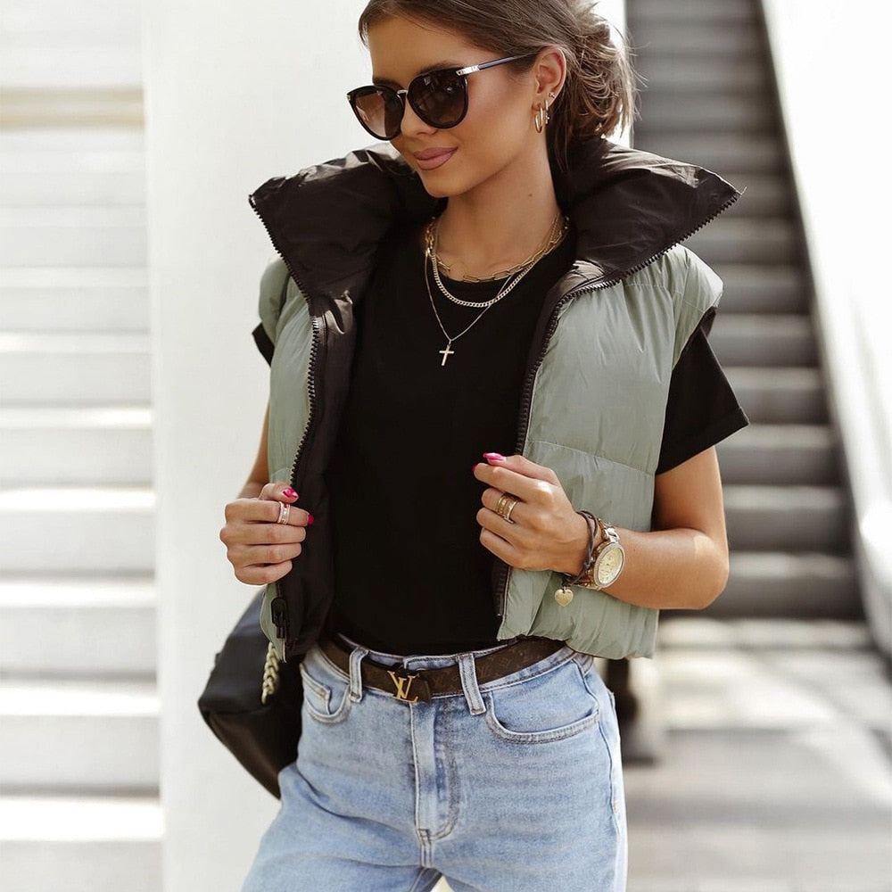 Women's quilted bodywarmer vest in black with green side panels and zip front