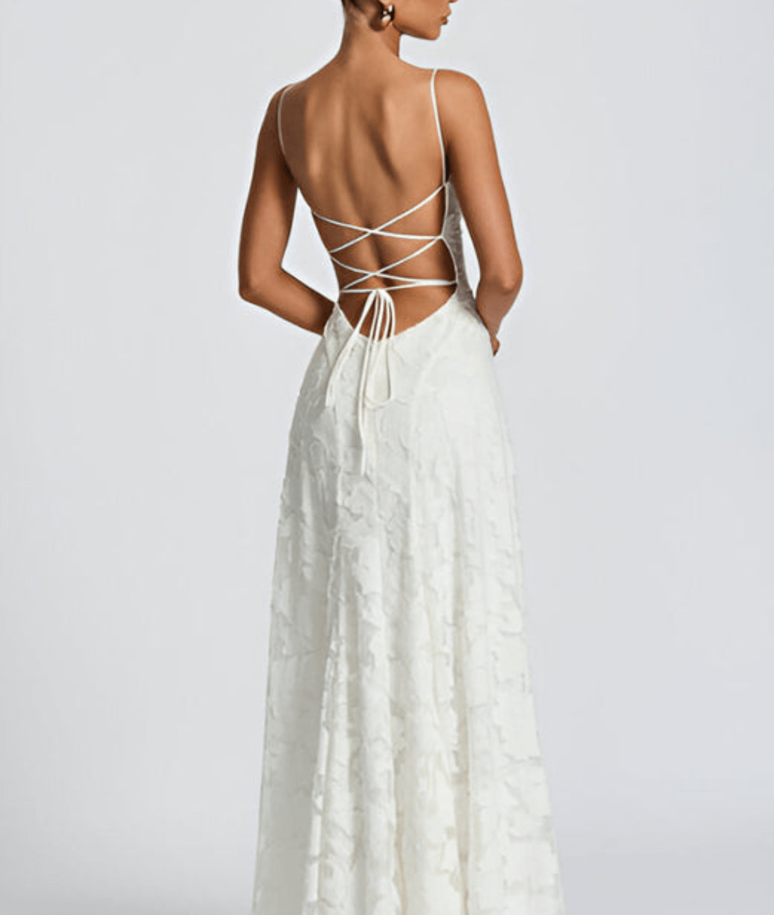 White maxi dress back with thin crisscross straps and open tied back